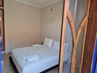 a bedroom with a bed with white sheets at Villa Kaina in Marrakech