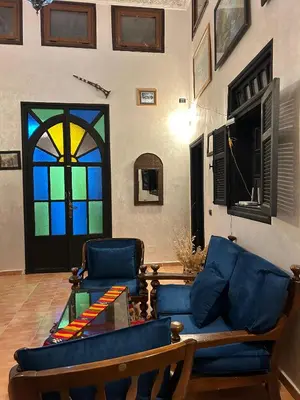 a living room with a couch and stained glass windows at Dar Daroune in Marrakech