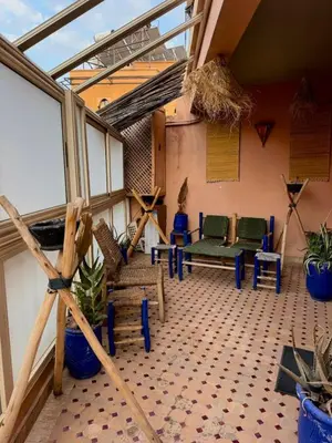 a room with a patio with chairs and plants at Happy House 2 in Marrakech