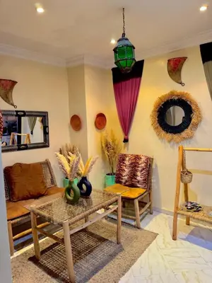 a living room with a table and a couch at Happy House 2 in Marrakech