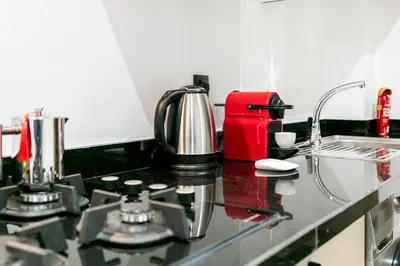 a kitchen counter with a coffee maker on it at Pearl of Nour Prestige in Marrakech
