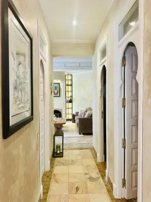 a hallway leading to a living room with a couch at Le Palmito - 2BDR - Private Garden - Pool in Marrakech