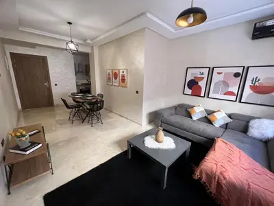 a living room with a couch and a table at Appartement magnifique in Marrakech