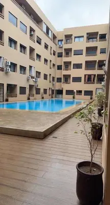 a large building with a potted tree in front of it at Appartement magnifique in Marrakech