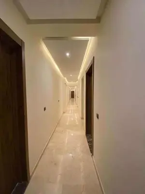 an empty hallway in a building with a long corridor at Appartement magnifique in Marrakech