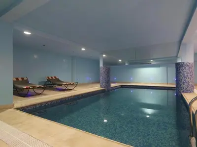 a swimming pool in a hotel room with chairs at Apartment Ghita Cozy Stay in Central Marrakech in Marrakech