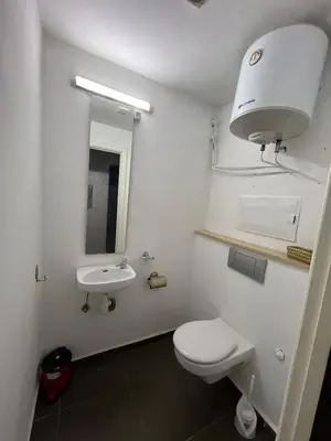 a white bathroom with a toilet and a sink at Apartment Ghita Cozy Stay in Central Marrakech in Marrakech