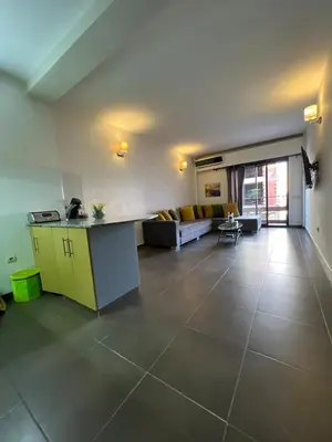 a living room with a yellow counter and a couch at Apartment Ghita Cozy Stay in Central Marrakech in Marrakech