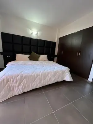 a bedroom with a large bed with a black headboard at Apartment Ghita Cozy Stay in Central Marrakech in Marrakech