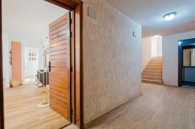 a hallway with a wooden door and a staircase at Elegant and Confort Moderne au Coeur de la Ville in Marrakech