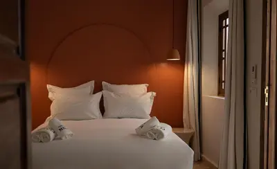 a white bed with towels on top of it at Riad Dar Melia in Marrakech