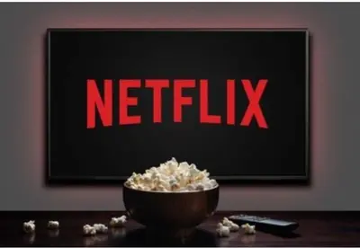 a netflix sign on a wall with a bowl of popcorn at Appart chaleureux et calme, fibre et Netflix in Marrakech