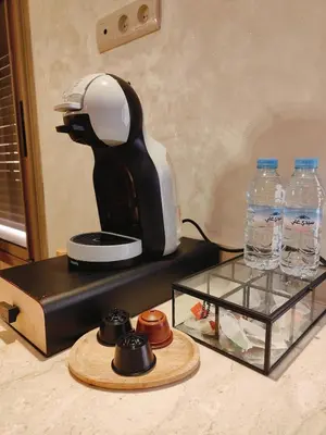 a coffee maker and two bottles of water on a counter at Appart chaleureux et calme, fibre et Netflix in Marrakech