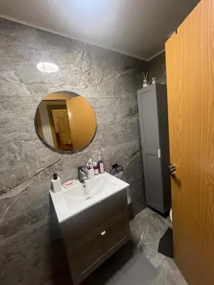 a bathroom with a sink and a mirror at Appartement Cosy Marrakech in Marrakech