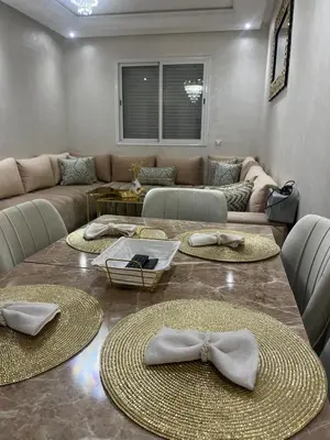 a living room with a couch and a table with bows at Appartement Cosy Marrakech in Marrakech