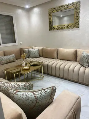 a living room with a large couch and a table at Appartement Cosy Marrakech in Marrakech