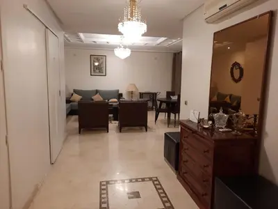 a living room with a couch and a dining room at Residence Sofia in Marrakech