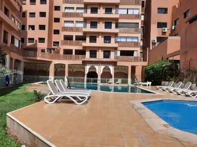 a couple of lounge chairs sitting next to a building at Residence Sofia in Marrakech