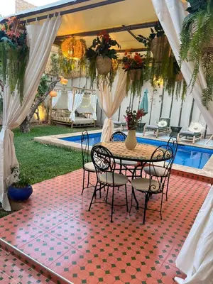 a patio with a table and chairs and a pool at Villa Elysia Marrakech, Piscine sans vis à vis in Marrakech