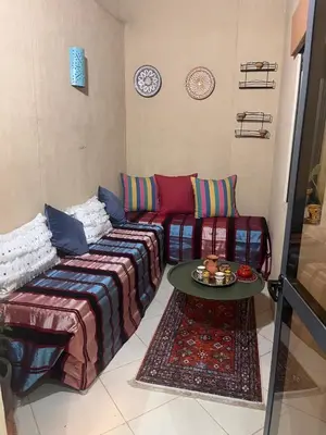 a living room with a couch and a table at Marrakech duplex apartment in Marrakech