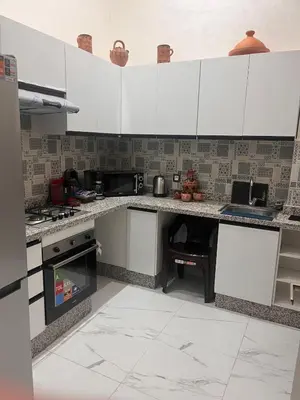 a kitchen with white counters and white cabinets at Marrakech duplex apartment in Marrakech