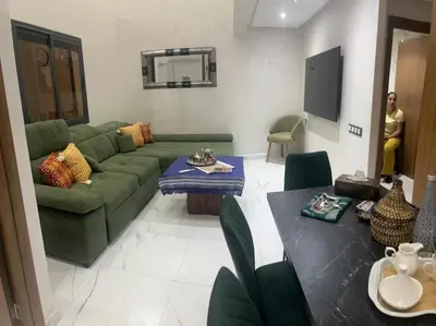 a living room with a green couch and a table at Marrakech duplex apartment in Marrakech