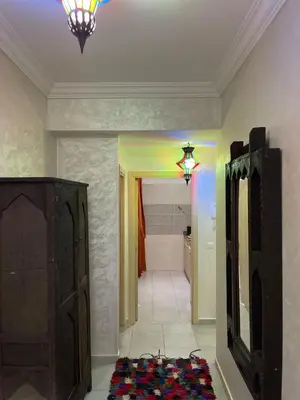 a room with a hallway with a mirror and a light at Airport Apartment in Marrakech