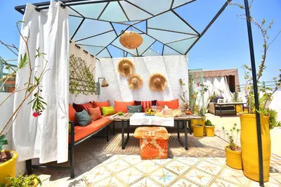a patio with a couch and a table at Beldi House in Marrakech