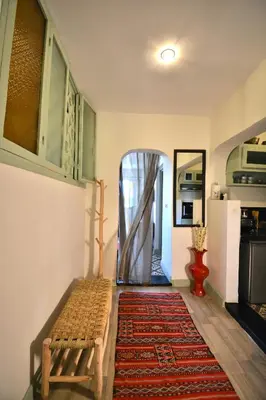 a hallway with a bench and a door to a kitchen at Beldi House in Marrakech