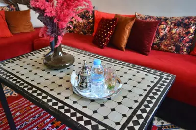 a table with bottles on top of a couch at Beldi House in Marrakech