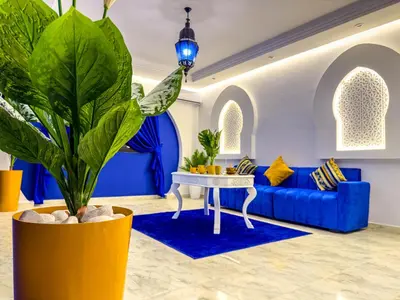 a living room with a blue couch and a blue table at Suite Majorelle l Gueliz,balcon,clim, Netflix,WiFi in Marrakech