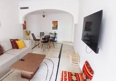 a living room with a couch and a table at Appart Majorelle in Marrakech