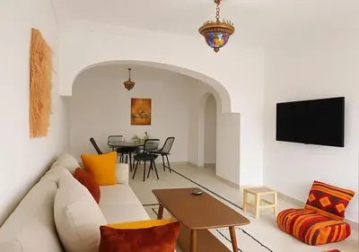 a living room with a couch and a table at Appart Majorelle in Marrakech