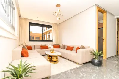 a living room with a couch and a table at Comfort & Elegance Marrakech in Marrakech