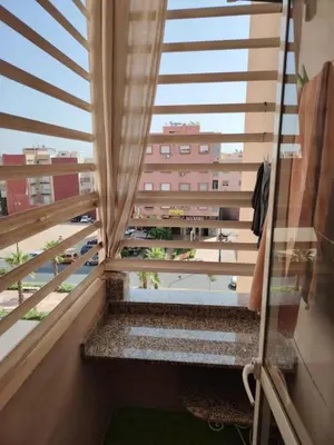 a balcony with a view of a building at Apartment heart of Marrakech in Marrakech