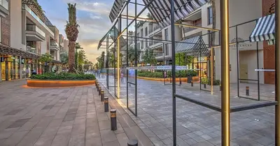 a street in a shopping mall with glass windows at M Résidence Marrakech Luxury Serviced Apartments in Marrakech