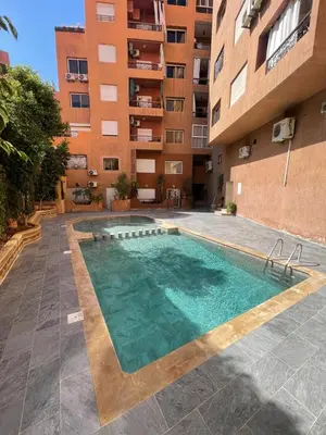 a swimming pool in the middle of a building at VERY RARE APARTMENT GUELIZ CENTER OF Marrakech in Marrakech