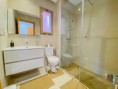 a bathroom with a shower and a toilet and a sink at Luxury Apartment in Prestigia Marrakech in Marrakech