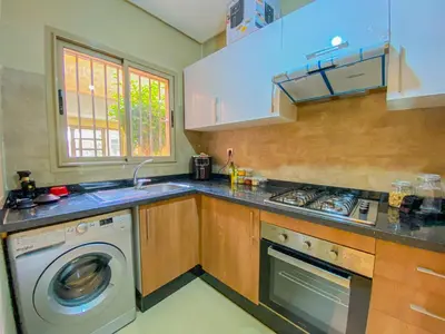 a kitchen with a washer and a washing machine at Luxury Apartment in Prestigia Marrakech in Marrakech