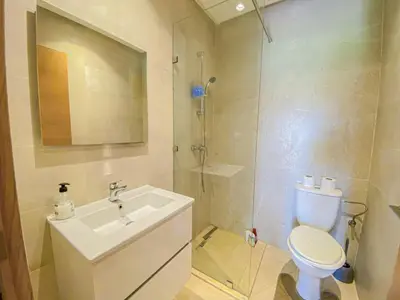 a bathroom with a sink and a toilet and a shower at Luxury Apartment in Prestigia Marrakech in Marrakech