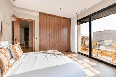 a bedroom with a large bed and a large window at Large Private Pool, Breakfast Included, Near Golf in El Rhechat