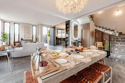 a dining room with a table with food on it at Large Private Pool, Breakfast Included, Near Golf in El Rhechat