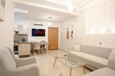 a living room with a couch and a table at La Vita Moderna Marrakech Pool in Marrakech