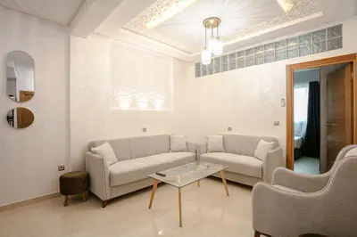 a living room with a couch and a table at La Vita Moderna Marrakech Pool in Marrakech