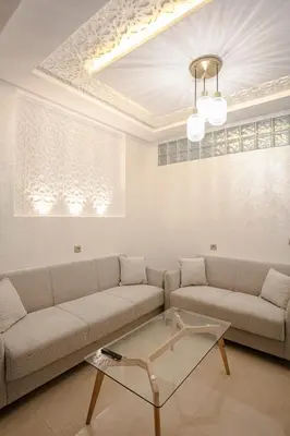 a living room with a couch and a table at La Vita Moderna Marrakech Pool in Marrakech