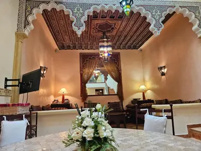 a dining room with a table with flowers on it at Riad zahra in Marrakech