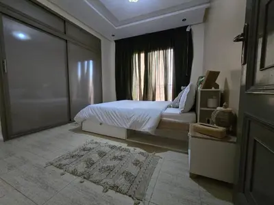 a bedroom with a bed and a window at Appartement Moderne Gueliz in Marrakech