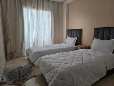a hotel room with two beds and a window at Appartement Moderne Gueliz in Marrakech