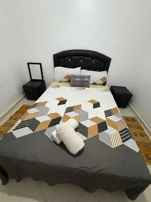 a bed with two pillows on top of it at Gueliz modern in Marrakech
