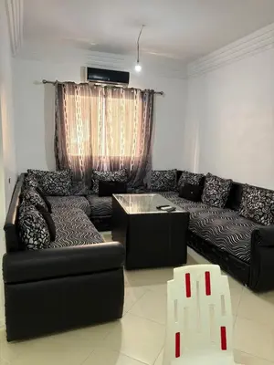 a living room with a black couch and a table at Gueliz modern in Marrakech